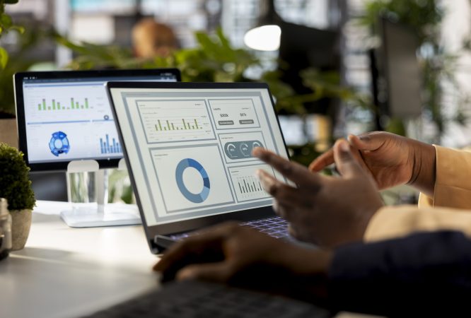 Business analyst meeting with a coworker to review financial report, leading a briefing presentation and exchanging ideas on enterprise development. Achieving goals for expansion.