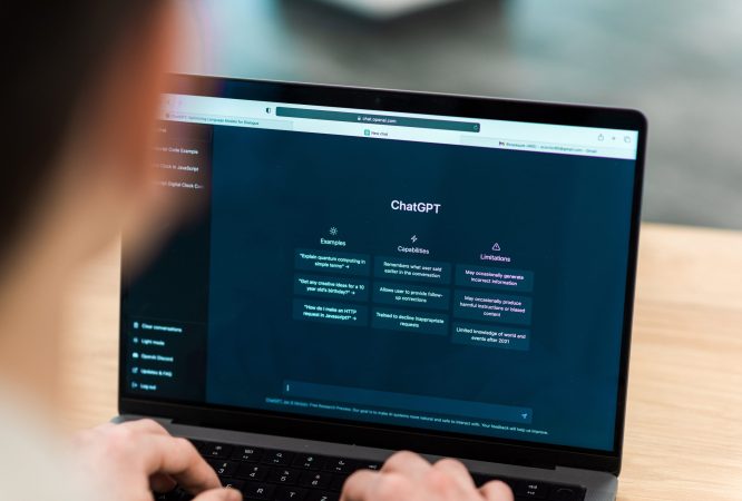 Close view of a man with opened AI chat on laptop