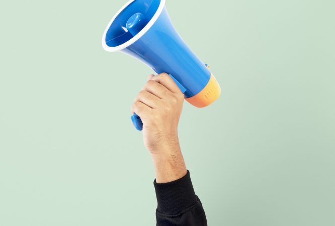 Hand holding megaphone marketing announcement campaign