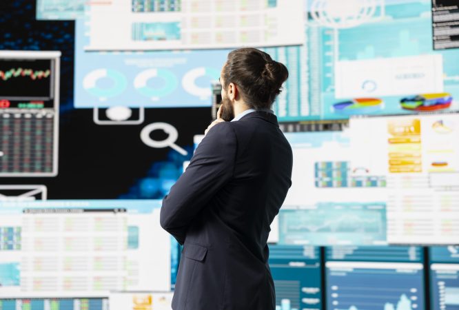 High end entrepreneur thinking about new powerful ideas for company profit growth, using analytics reports and KPI projections to guide his strategic decision making. Forecasting.